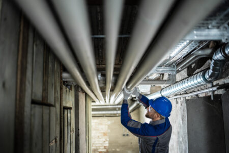 Plumber inspecting pipes